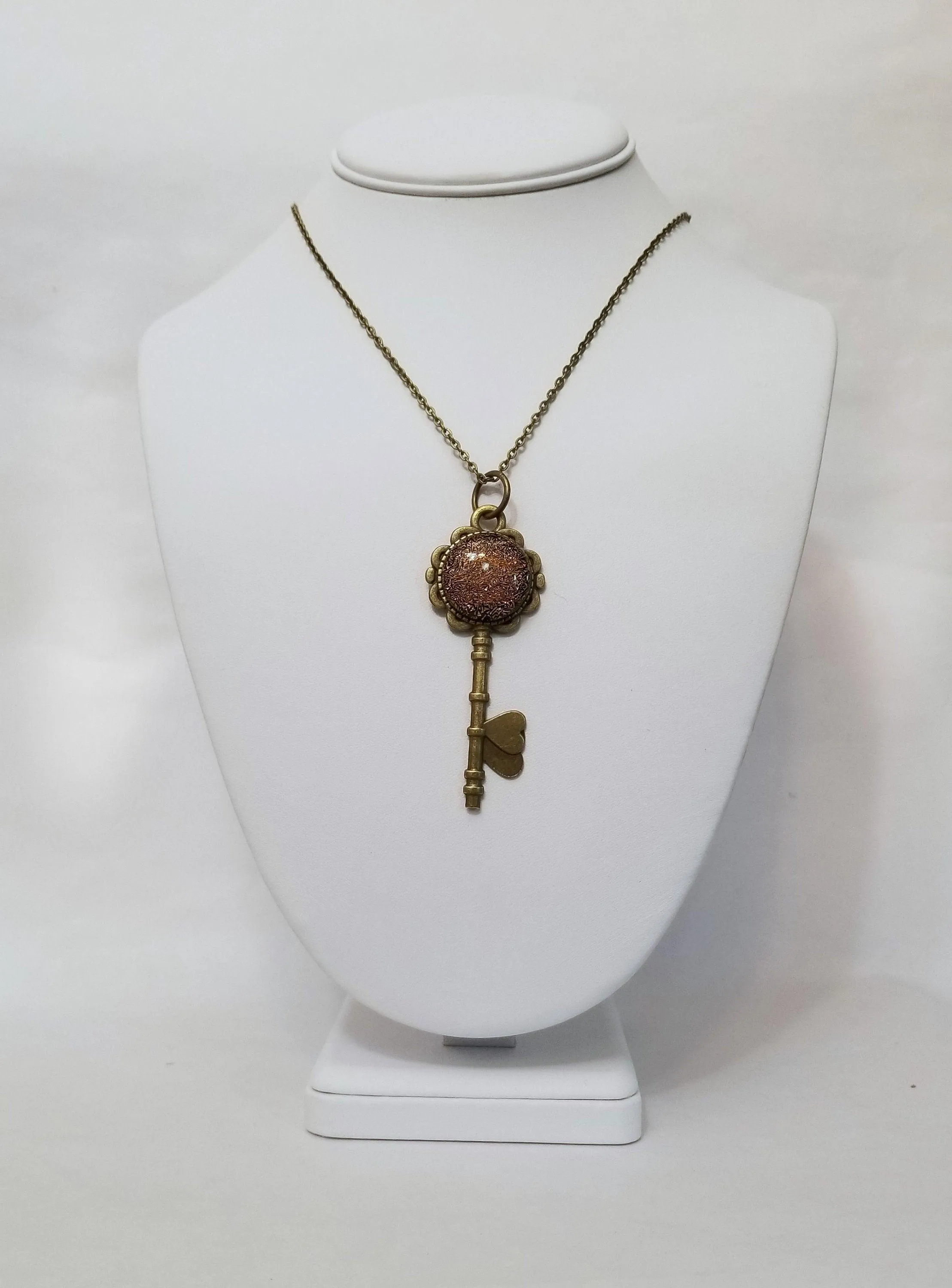 Antiqued Brass Flowered Skeleton Key with Fused Glass Orange Dichroic cabochon on 24 inch brass plated chain