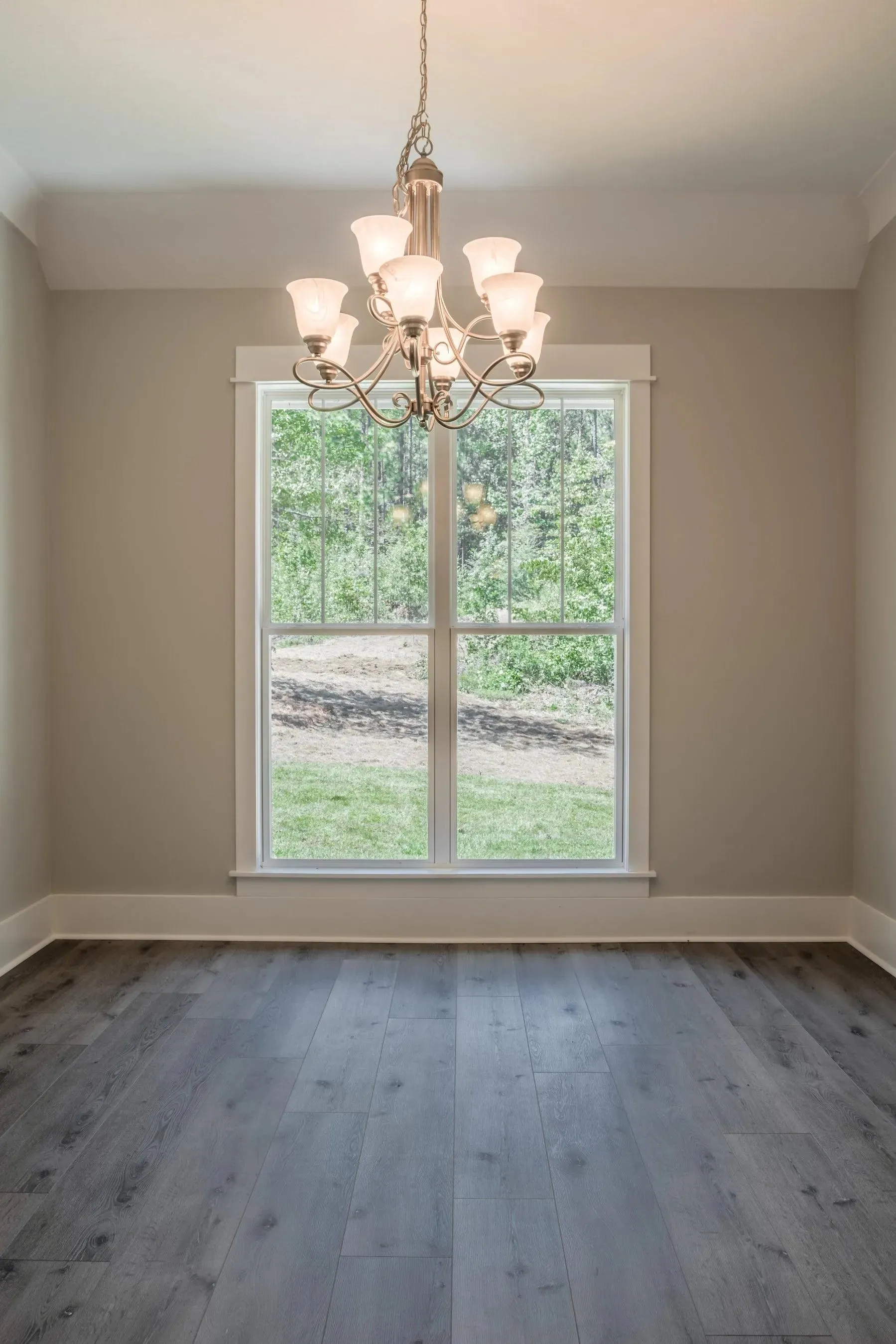Elegant family home with spacious living, bonus room, and outdoor kitchen.